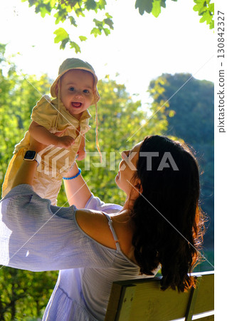 Mother and Baby Enjoying Sunny Day in Park 130842327