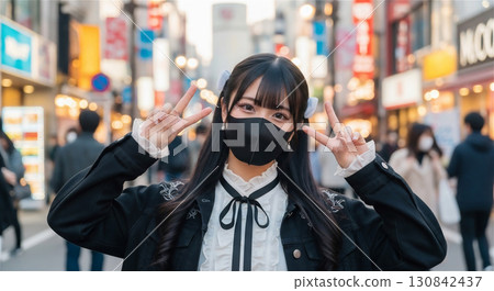 Portrait of a woman wearing a black mask | Posing cheerfully in the city 130842437