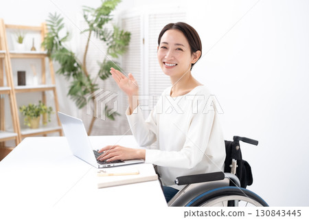 Woman in wheelchair, computer Woman in wheelchair, computer 130843445