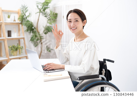 Woman in wheelchair, computer Woman in wheelchair, computer 130843446