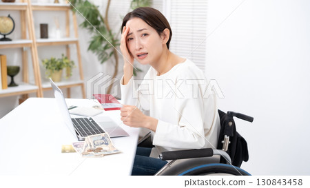 Woman in wheelchair worries about money 130843458