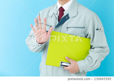 A middle-aged male businessman in work clothes holding a binder and raising five fingers A middle-aged male businessman in work clothes holding a binder and raising five fingers 130843595