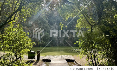 A pond surrounded by forest and cliffs (daytime natural scenery) A pond surrounded by forest and cliffs (daytime natural scenery) 130843810