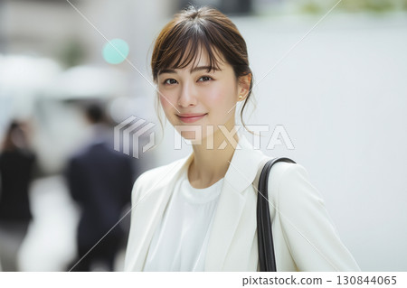 A smiling young woman in a recruitment suit looking for a job 130844065