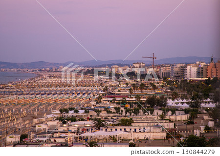 Beach infrastructure Italy resort Rimini city Wide sandy coastline. Evening seashore. Italian resort hotels on embankment 130844279