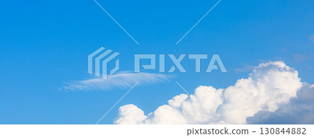 A simple landscape of blue sky and fluffy white clouds A simple landscape of blue sky and fluffy white clouds 130844882