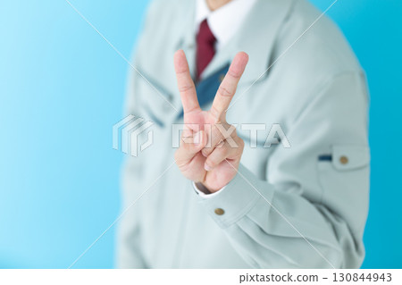 A middle-aged male businessman in work clothes holding up two fingers 130844943