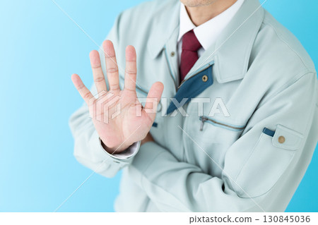 A middle-aged male businessman in work clothes holding up five fingers A middle-aged male businessman in work clothes holding up five fingers 130845036