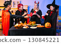 Dinner and group of people celebrating together at Halloween party. 130845221
