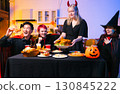 Dinner and group of people celebrating together at Halloween party. 130845222