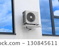 Condenser unit or compressor outside of residential building. Unit of central air conditioner AC or heating ventilation air conditioning system HVAC. Electric fan AC hangs on the wall 130845611