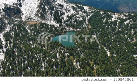 Mountain lake with snow mountains and green forest Mountain lake with snow mountains and green forest 130845861