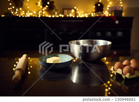 Homemade Baking Preparation with Butter, Eggs and Tools in Festive Lighting Homemade Baking Preparation with Butter, Eggs and Tools in Festive Lighting 130846081