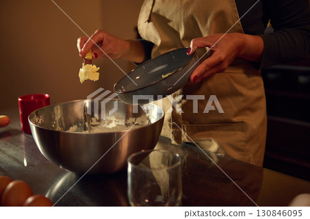 Woman Preparing Dough for Baking in a Warm, Inviting Kitchen Setting Woman Preparing Dough for Baking in a Warm, Inviting Kitchen Setting 130846095