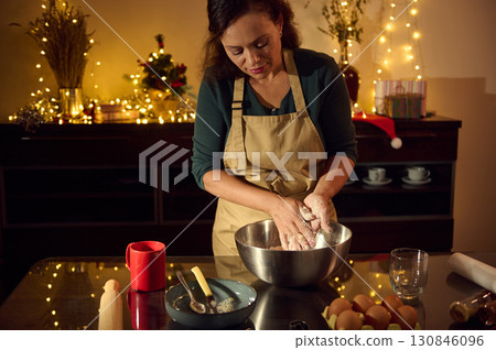 Woman Baking Christmas Cookies in a Festive Kitchen Setting Woman Baking Christmas Cookies in a Festive Kitchen Setting 130846096