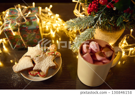 Festive Christmas Scene with Cookies, Hot Cocoa, and Holiday Decorations 130846158