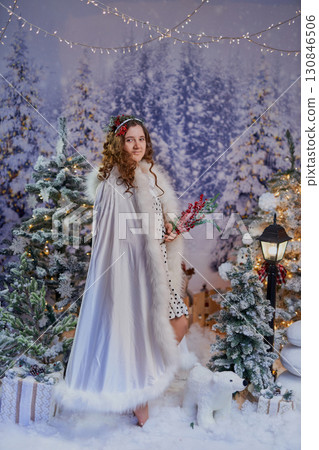Festive girl in a winter wonderland Festive girl in a winter wonderland 130846506