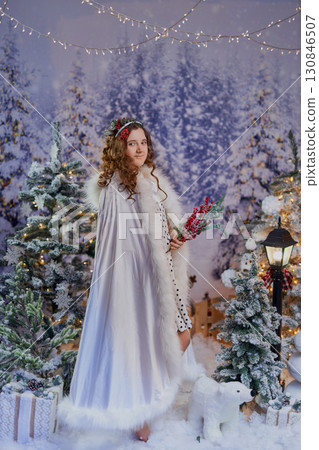 Festive girl in a winter wonderland 130846507