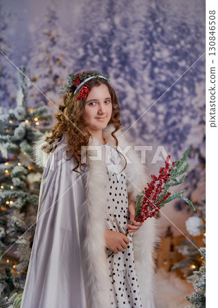 Festive girl in a winter wonderland Festive girl in a winter wonderland 130846508