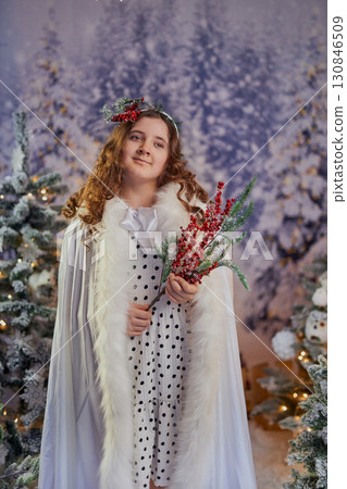 Festive girl in a winter wonderland 130846509