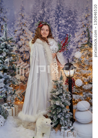 Festive girl in a winter wonderland 130846510