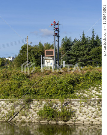 Dam discharge warning station installed along the river Dam discharge warning station installed along the river 130846802