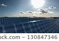 Solar panel background of photovoltaic modules for renewable energy. Clouds and blue sky in mirror. Alternative electricity source. 3d rendering. 3d illustration 130847346