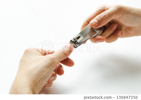 Nail clippers: A woman's hands cutting her nails Nail clippers: A woman's hands cutting her nails 130847350