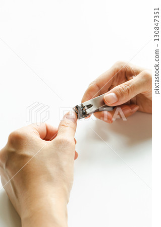 Nail clippers: A woman's hands cutting her nails 130847351