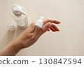 Dropper with serum on female hand neutral minimal skincare concept 130847594