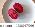 Cutted pink prickly pear cactus fruit on ceramic plate, close-up 130847596