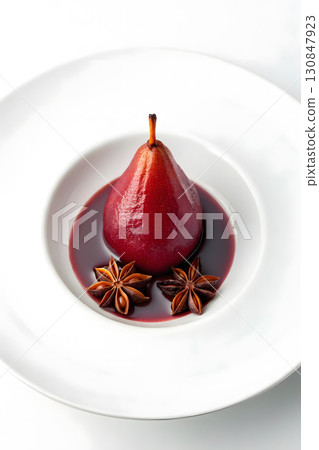 Elegant poached pear served in rich red wine sauce with star anise garnish 130847923