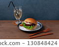 Teriyaki burger on a plate on a wooden table 130848424