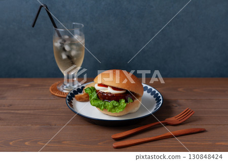 Teriyaki burger on a plate on a wooden table 130848424