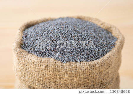 High quality poppy seed in linen sack close up. Small beautiful bag with poppy seed 130848668