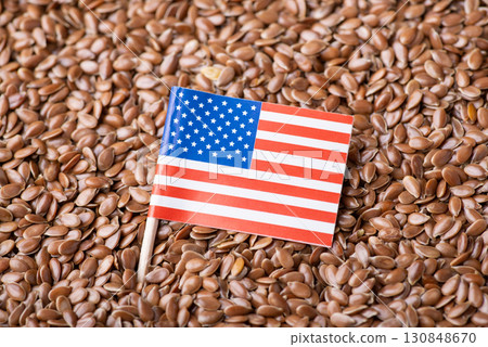 Small flag of USA on linen grain. Origin of grain, growing linen seed in USA concept 130848670