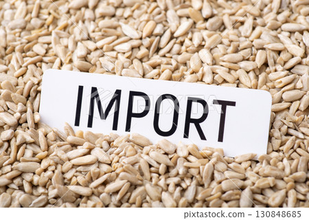 Paper with inscription Import on sunflower seeds grain. Concept of trade of sunflower grain between countries 130848685