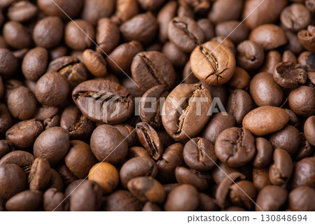 Close up of roasted coffee beans. Aromatic dark coffee beans Close up of roasted coffee beans. Aromatic dark coffee beans 130848694