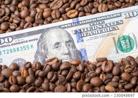 Dollar banknote in coffee grain. Coffee business concept, price on coffee beans 130848697