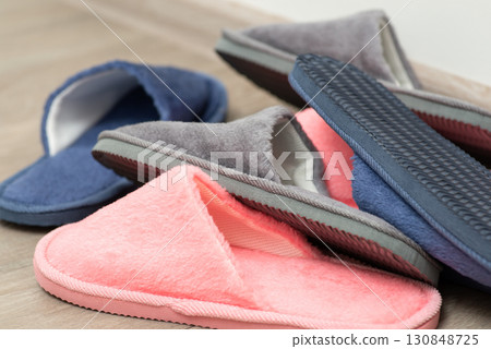 Home footwear lie in chaos on the floor. Disorder at home with slippers 130848725