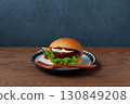 Teriyaki burger on a plate on a wooden table 130849208