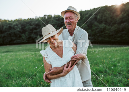 Elderly man and woman spending time in nature. Elderly man and woman spending time in nature. 130849649