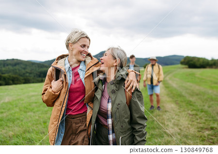 Mature daughter and her mom on hiking trip in nature. Mature daughter and her mom on hiking trip in nature. 130849768