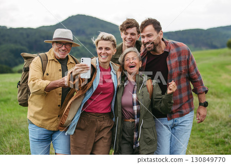 Family taking selfie on hiking trip in the nature. 130849770