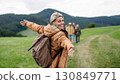 Portrait of beautiful woman during family hiking trip in nature. 130849771