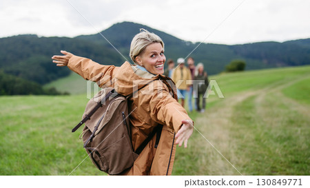 Portrait of beautiful woman during family hiking trip in nature. 130849771