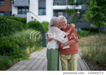 Portrait of beautiful adult daughter with old mother. Portrait of beautiful adult daughter with old mother. 130849773