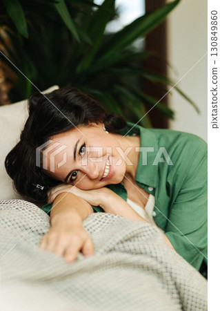 Portrait of woman with hair rollers during slow morning. 130849860