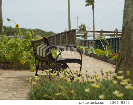 Quiet walking path with flower beds and benches 130849861