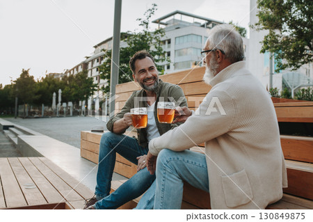 Happy father and son sharing drinks on a sunny day 130849875
